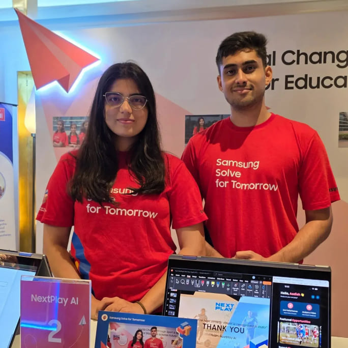 Aadish Abhijeet Shelke and Bhagyashri Heeralal Meena, co-founders of NextPlayAI, are being photographed at the company’s exhibition booth.