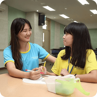 Samsung DreamClass mentor and mentee smiling while looking at each other