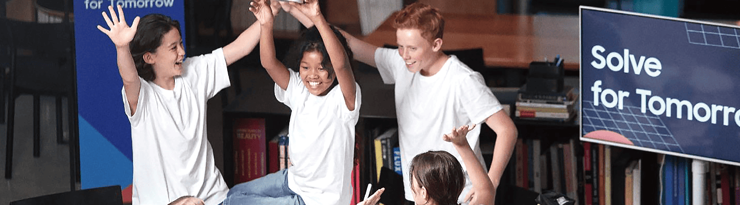 Students participating in Samsung Solve for Tomorrow are cheering together with their teammates.