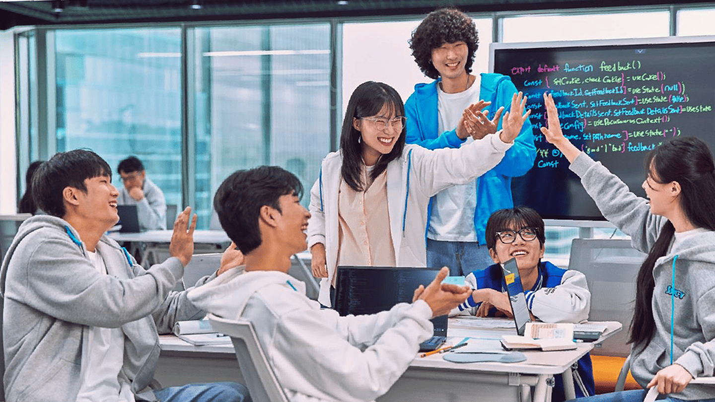 SSAFY trainees laughing and giving high-fives together