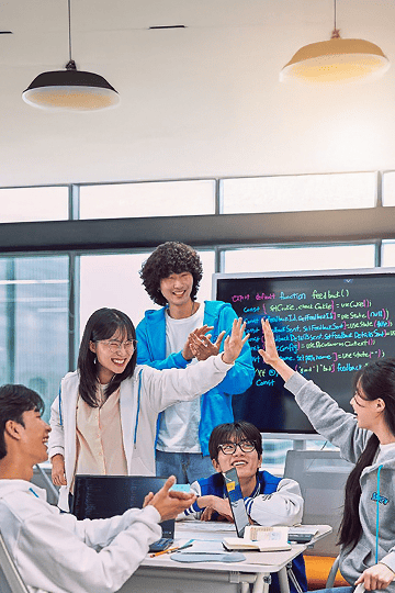 SSAFY trainees laughing and giving high-fives together